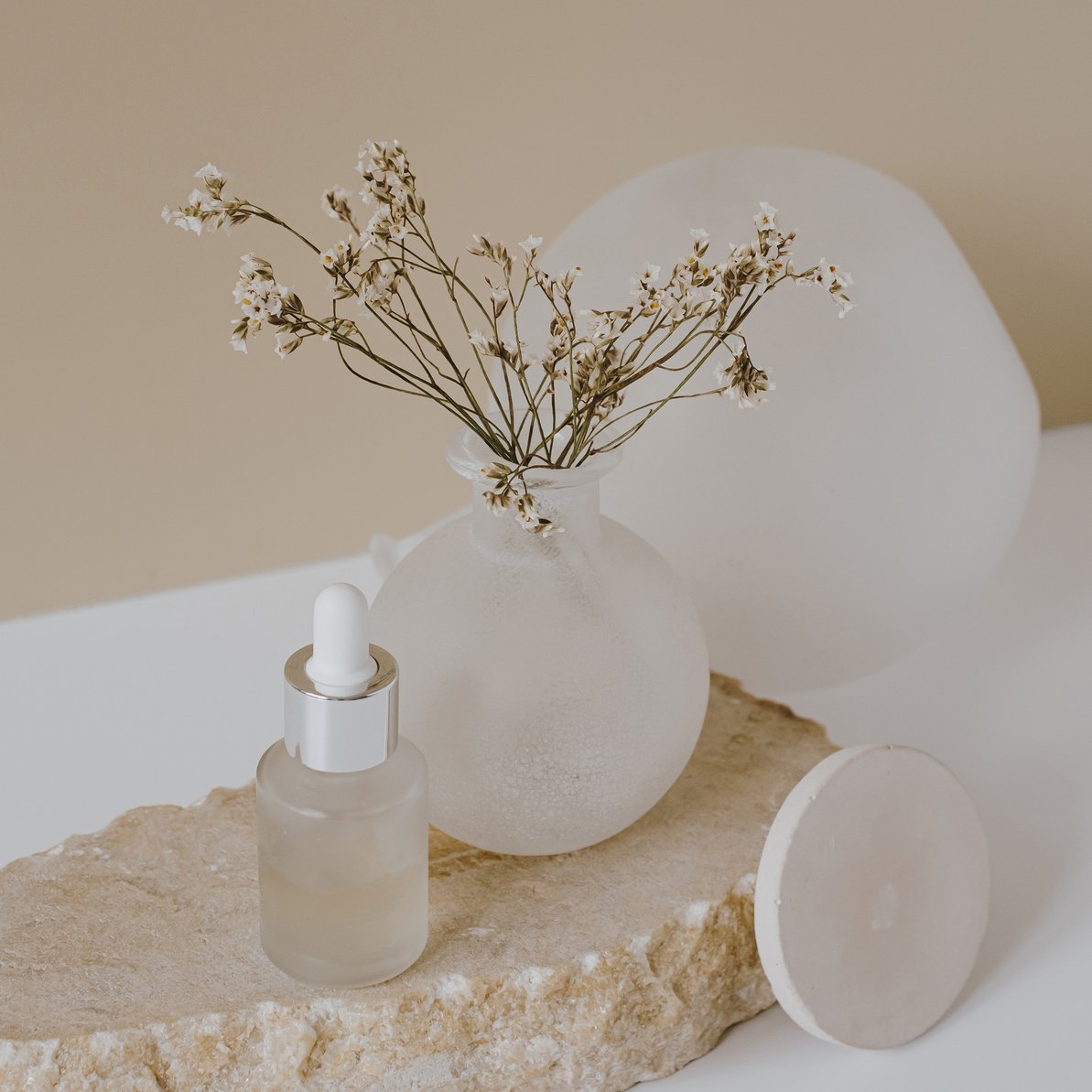 Serum Oil Glass Bottle With Flowers in a Vase 